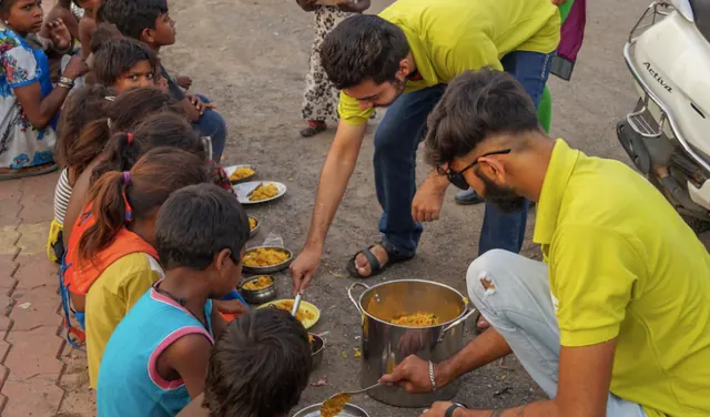 Volunteers serving food to children with respect